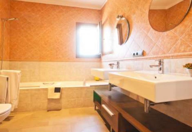 Bathroom with bathtub and two sinks