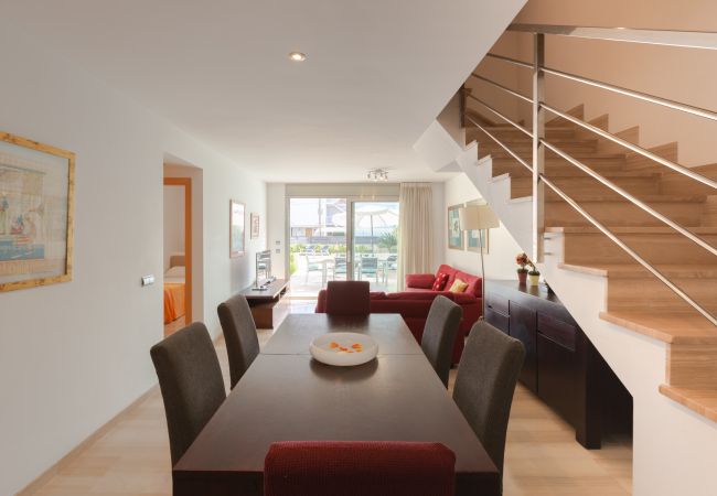 Lighted dining room with sofas and table