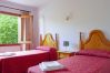 Room with 2 single beds with sheets and towels