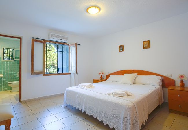 Bedroom with double bed and bathroom