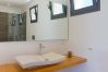Washbasin and bathroom mirror en suite with shower.