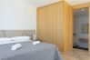 Bedroom with private bathroom and large wooden wardrobe